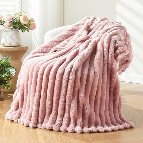 Fleece throw blanket that's soft and cozy, ideal for snuggling on the couch. **“For evenings that call for softness and stillness.”**